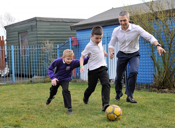 Matt Beeton practising his football skills with some of children from the Connected Kids Club